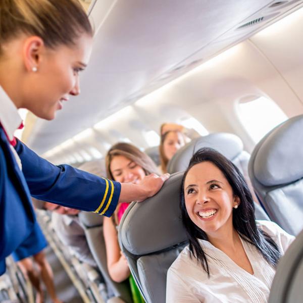 Flight attendant speaking with the passenger