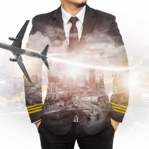 Pilot standing in front of the city view where plane is flying